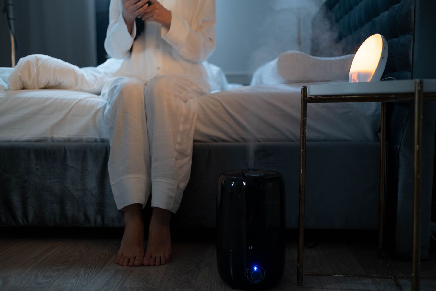 A humidifier in a softly lit bedroom
