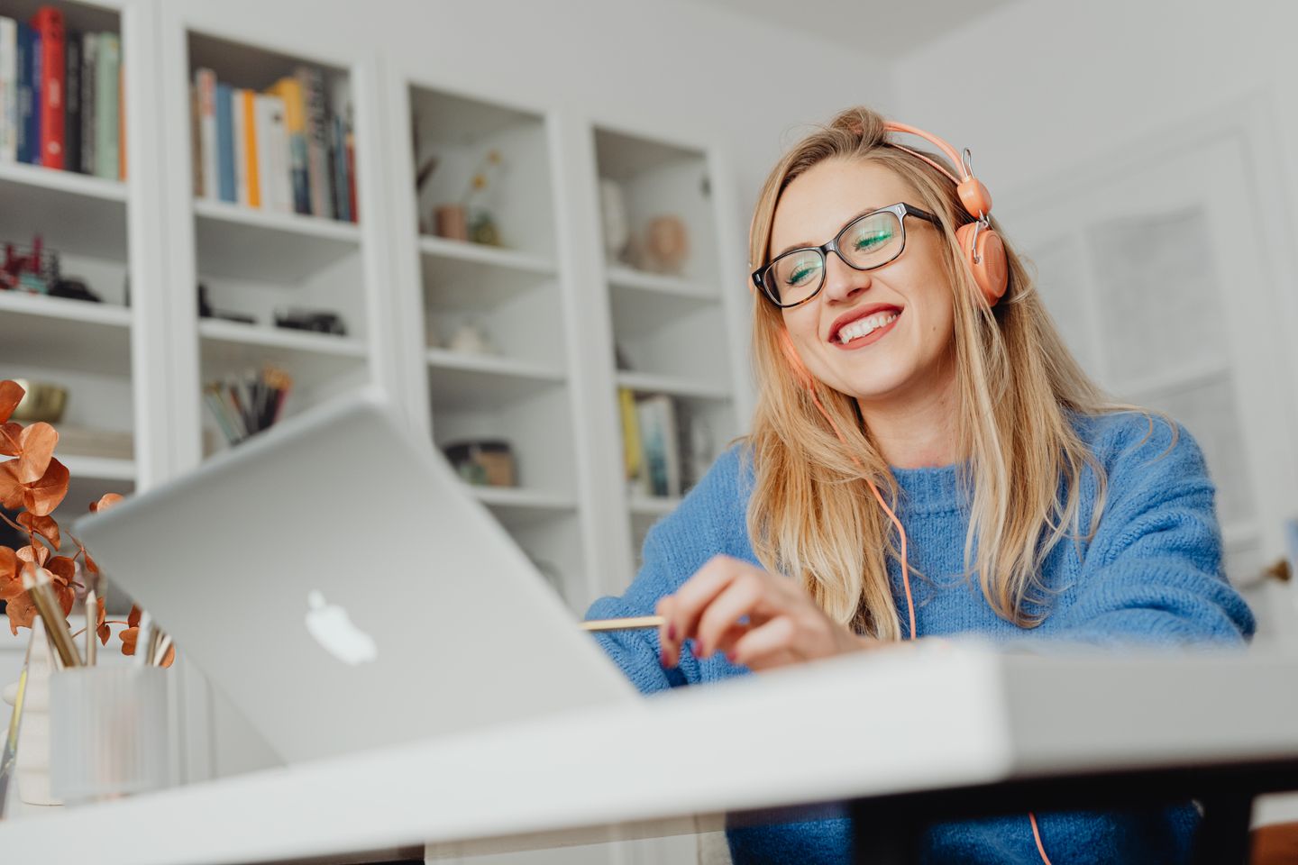 A person working from a laptop in a comfortable home setting
